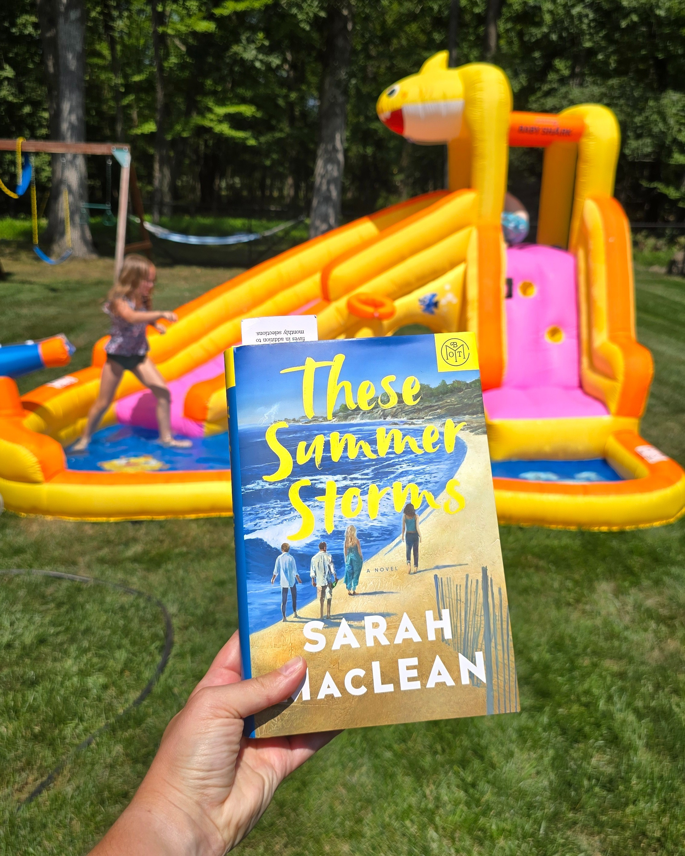 ☀️ Backyard magic in full swing! The kids are burning energy on the Funormous Water Slide, while I sneak a quiet moment with These Summer Storms by Sarah MacLean_ 🌊📖.

#LTKSeasonal #LTKFamily #LTKKids