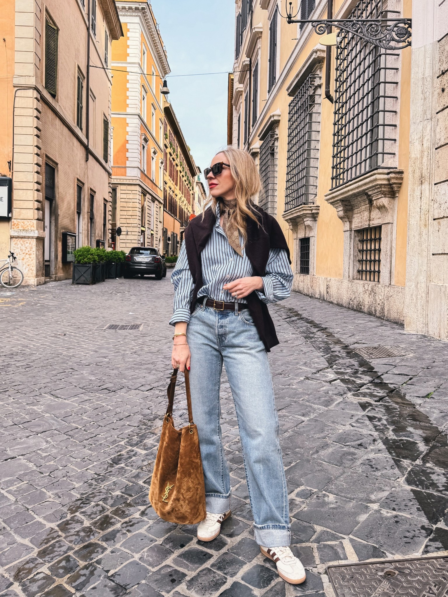 European vacation outfit, travel look, @Zara striped shirt, @Levi's cuffed baggy 90’s jeans, Adidas Samba sneakers, YSL suede bucket bag 

#LTKTravel #LTKOver40 #LTKSaleAlert