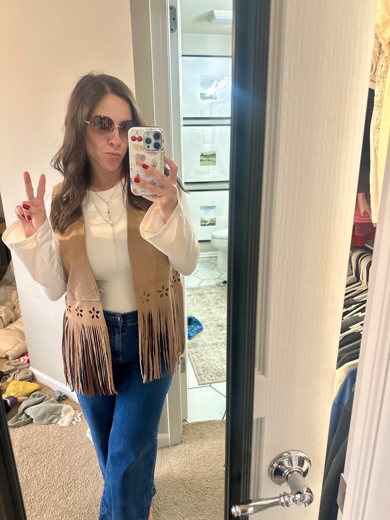 This fringe vest layered over a simple fitted top and wide leg jeans was perfect for a “Young Wild & Three” birthday party. It adds a retro touch without feeling like a costume.