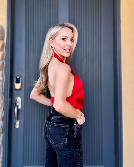 This red satin halter neck top would be super cute for the entire festive season to create lots of glam holiday outfits and Christmas party outfits with. Plus it’s under $60 and comes in lots more colors. Dress it up with a tulle skirt or leather skirt or down with jeans. I find it runs true to size. Black Agolde jeans on repeat 🖤 

#LTKfindsunder100 #LTKHoliday #LTKstyletip