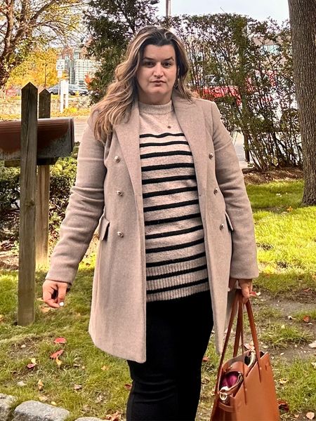Neutral beige coat with gold buttons wearing XL Mango still has the black color left striped long sleeve sweater wearing Large black ponte pants wearing size large and light brown / cognac work bags. Work fall winter outfit 

#LTKitbag #LTKSeasonal #LTKstyletip