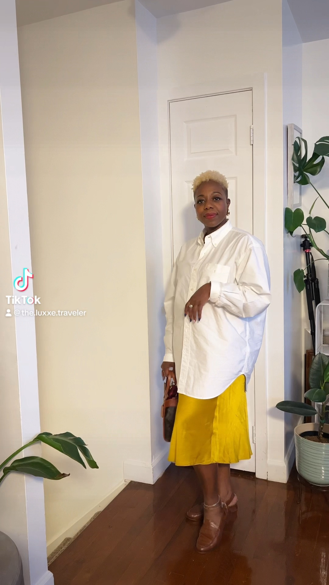Work outfit idea. 
You can never go wrong with an oversize white button up shirt. This is a staple in my closet all year round and it is one of the most versatile pieces that I own. Here I am wearing it with a satin skirt, some statement earrings, and a red lip to give this masculine shirt a feminine touch. 