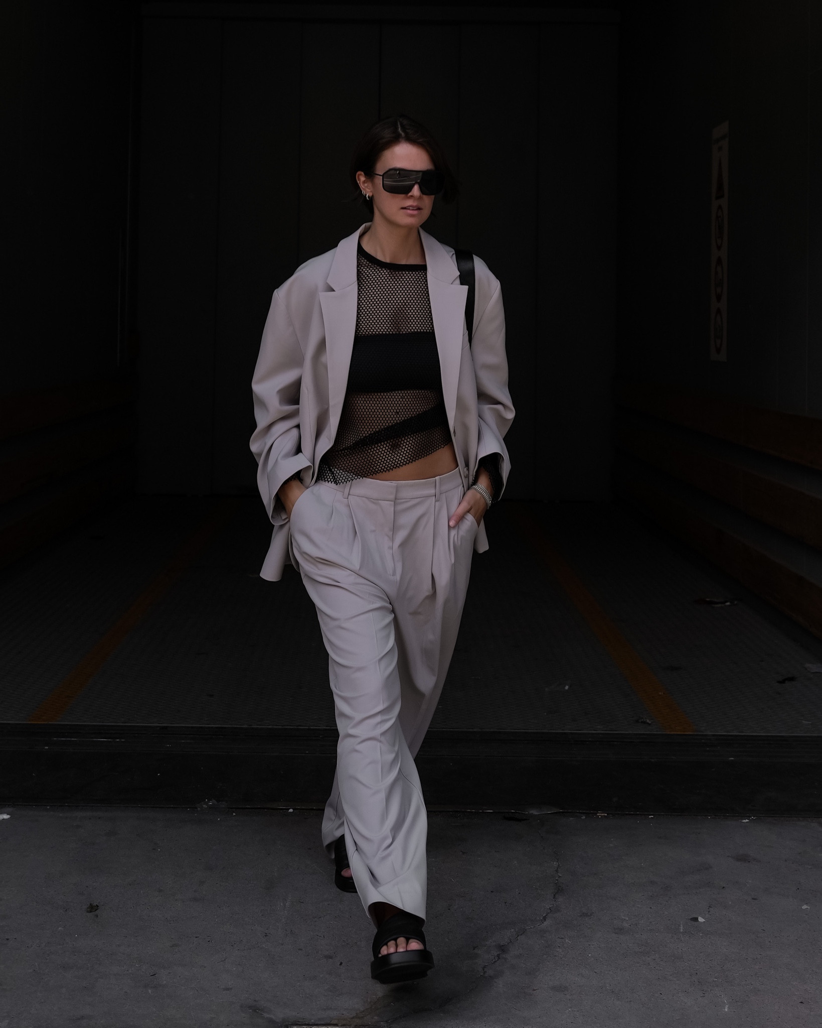 Love an oversized suit. Styled with a mesh shirt and chunky slides for a cool look. 