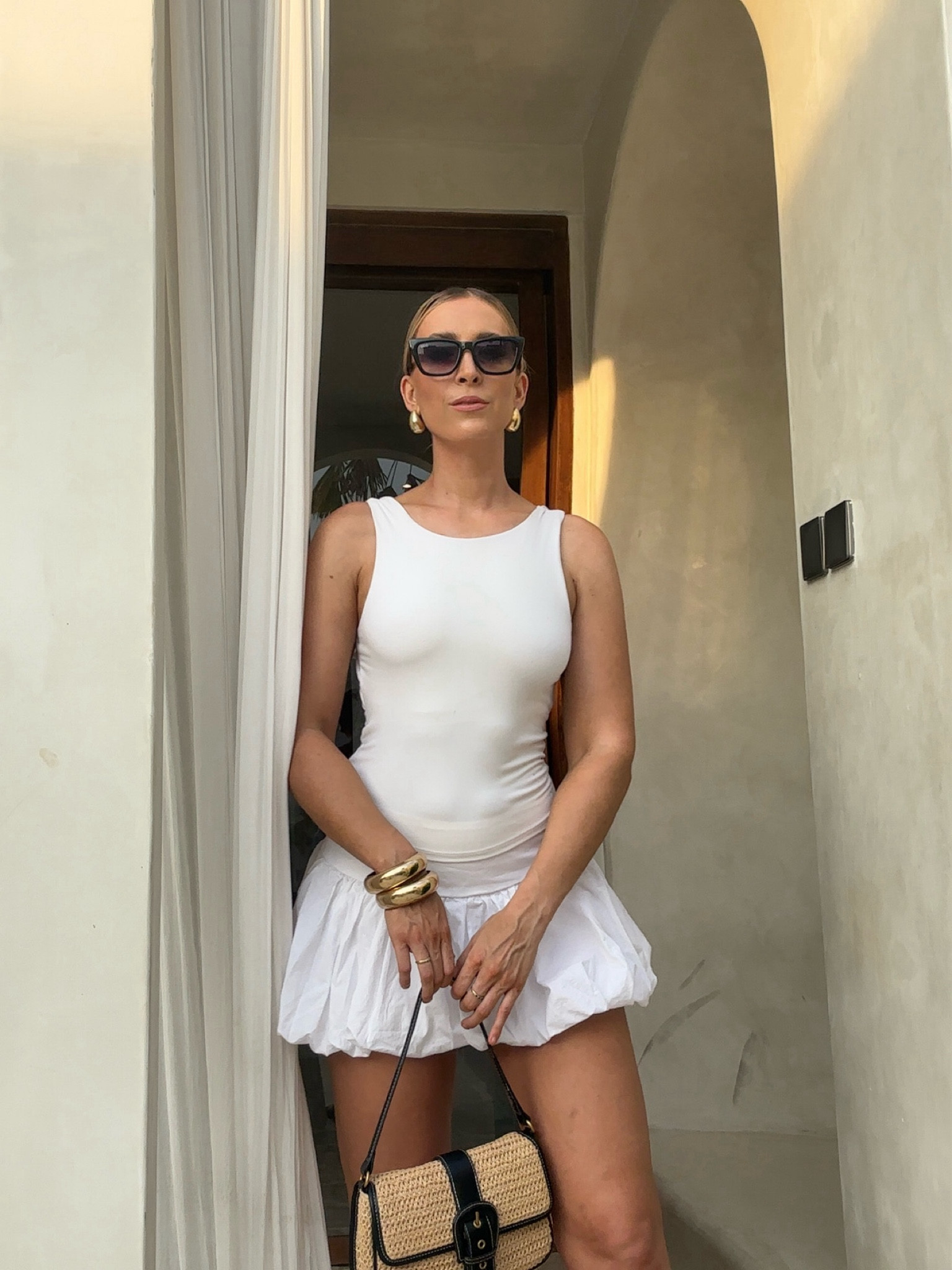 Trending all white look featuring white tank, white bubble skirt, gold bangles stack, classic black sunglasses, structured sandal and straw bag. Perfect for shopping trips, vacations and lunches with the girls 

#LTKaustralia #LTKtravel #LTKfindsunder100