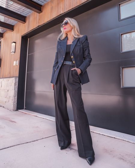 This is an easy, chic desk-to-dinner look! I’m wearing a Veronica Beard denim blazer with a pair of black Favorite Daughter wide-leg pants. These are the “Shortie” pants, but they also come in a regular length. Even the Shortie length is a little long on me (I’m 5’4”) so I have to wear heels. The wide-leg is SO flattering and I love that the pleating isn’t too overwhelming in the midsection.

Under the blazer, I’m wearing a black knit top by Open Edit. It’s thick and structured enough to wear without a bra if you are smaller-chested. If you need a bra, I would suggest strapless since the neckline is square and the straps on a regular bra would likely show. The top is cropped and body-skimming so tucking isn’t an issue- a must with pleated pants, so you don’t add bulk around the tummy.

I completed the look with a classic pair of black booties, a black belt, and cool Quay cat-eye sunglasses, but you could make accessory swaps to make it more or less work-appropriate. This is such a modern, unexpected office outfit idea that will easily transition to dinner. If you want to add more va-va-voom, take your blazer off when you get to dinner to show off the sexy square neckline of the top. All of these pieces run true to size.

~Erin xo 

#LTKstyletip #LTKover40 #LTKworkwear