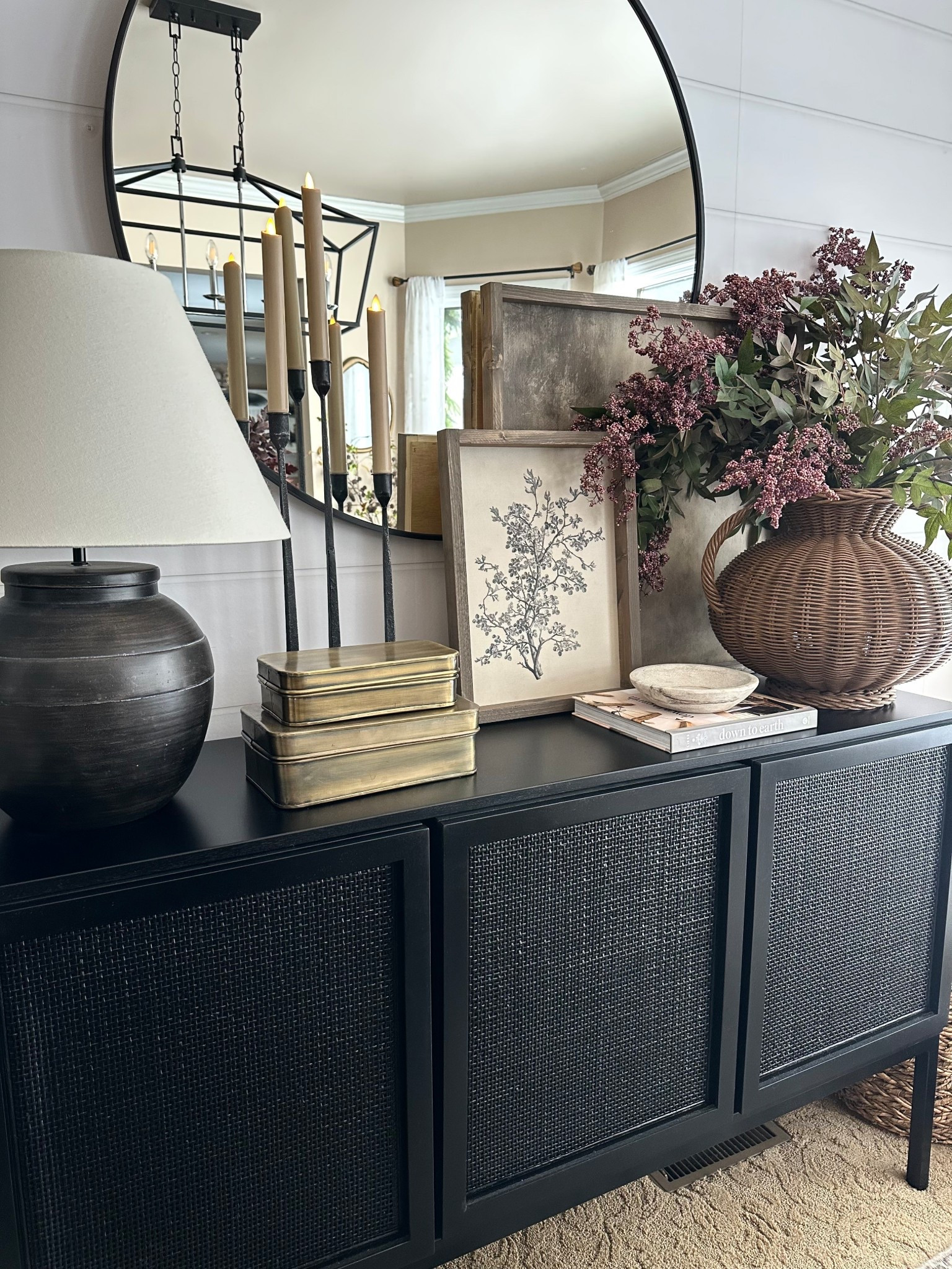 Neutral Dining Room Sideboard Styling Ideas

Follow @farmtotablecreations on Instagram for more neutral home styling ideas.

A look at how I styled this dining room sideboard with layered neutral artwork, taper candles, brass storage boxes, and a woven vase filled with faux stems. Mixing warm wood tones, brass accents, and natural textures helps create a cozy, collected look while the large round mirror reflects light and makes the space feel even more open.

#sideboard #diningroomdecor #diningroomsideboard #consoletablestyling #neutraldecor #tapercandles #wovenbasket #diningroomfurniture #homedecor #wallmirror #homeaccents

#LTKHome #LTKSaleAlert