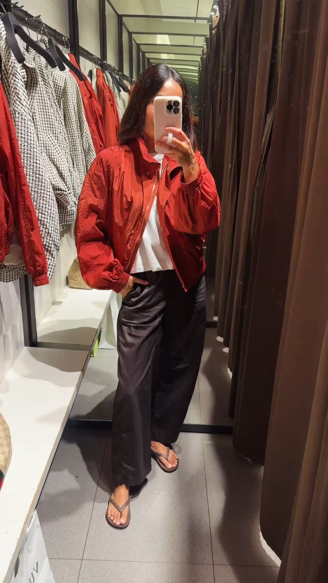 Fall transition outfit. Bomber jacket. 
I love this bomber jacket!  It’s like an elevated windbreaker style. The color is a beautiful warm red with chic details. Lightweight and water resistant. True to size.
Favorite cotton t-shirt. I take both true to size and a size up for different looks. 
Favorite poplin cotton pants that I wear lots. I size down. 
Flip flops with arch support. True to size.