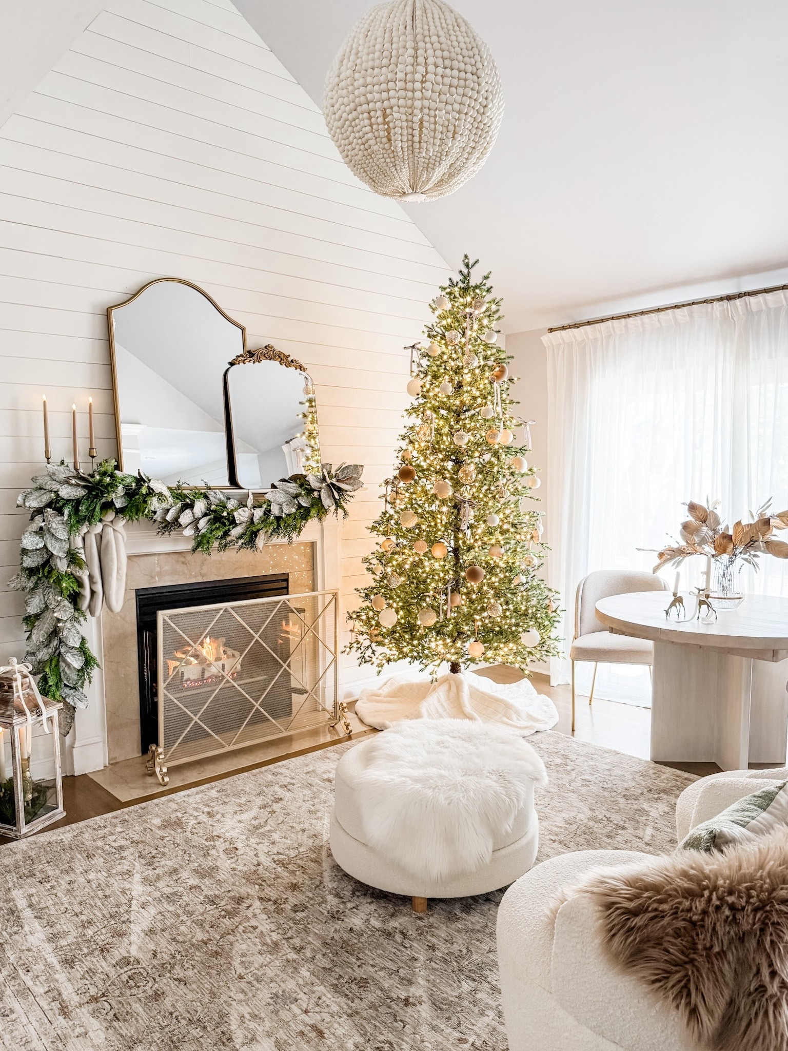 Christmas decor
Christmas dining room 
Round extendable dining table 
Pottery Barn cayman dining table
Living room area rug
Round ottoman
Faux fur rug
Mantel decor
Afloral real touch Norfolk pine garland
Christmas mantel
Taper candles
Gold candle holders
Arched mantel mirror
Fireplace screen
Fire screen
Swivel chair
9ft elegant twinkling grand fir LED pre lit artificial Christmas tree with timer 
Home Depot Christmas tree
Pinch pleat curtains
Gold curtain rod
Sliding door curtains 
Beaded chandelier 

#LTKHome #LTKHoliday #LTKSeasonal