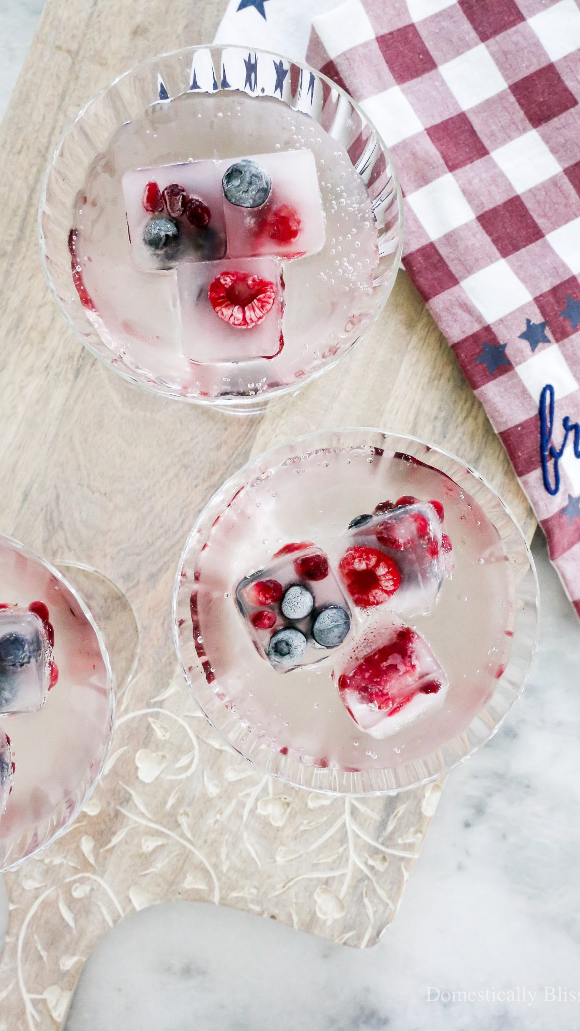 Easy DIY Patriotic Fruit Ice made with fresh raspberries, blueberries, and pomegranate seeds with a little trick to make the ice more clear.

See details:
https://domesticallyblissful.com/patriotic-fruit-ice/

🔗 Join our newsletter: https://domesticallyblissful.com/newsletter/ 

#LTKSummerEdit #LTKParties #LTKSeasonal