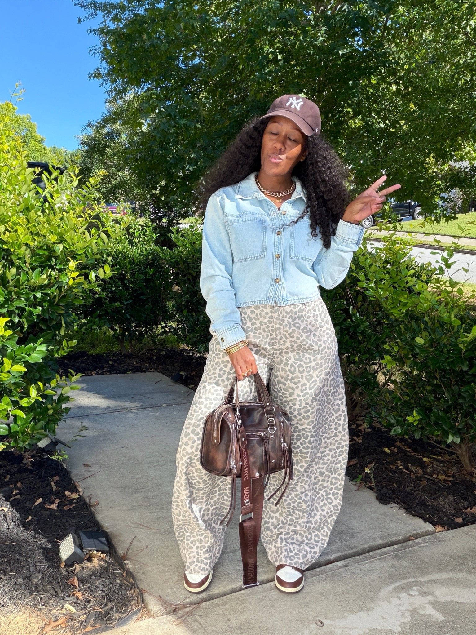 How I style leopard print pants with a denim shirt, brown NY baseball hat, brown faux leather bag, and brown and white Nike dunk low cacao wow sneakers

#LTKootd #LTKOver40 #LTKPetite