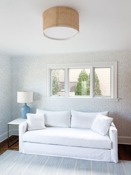White couch, blue and white home decor, flush mount light, rattan light, blue lamp, blue rug, wallpaper 

#LTKhome