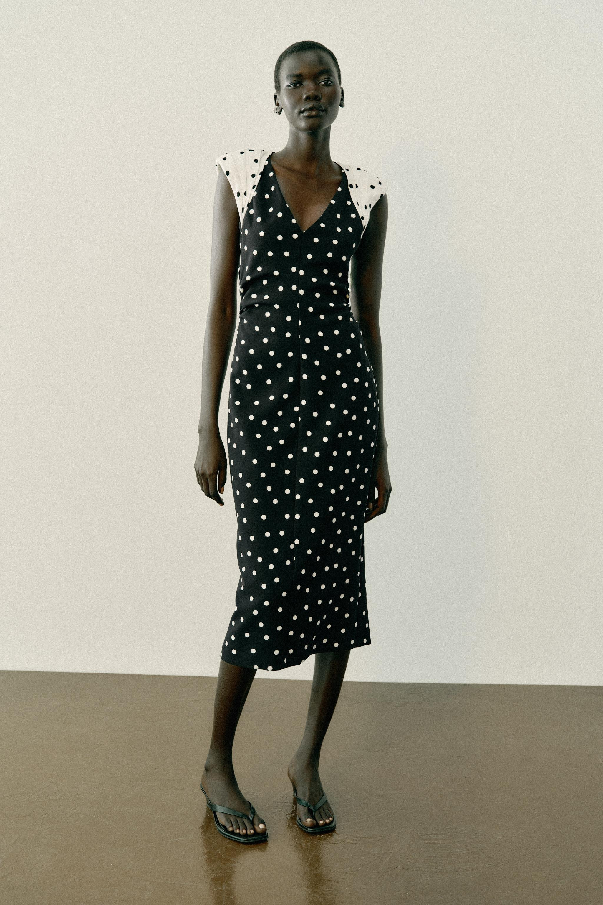 V-neck midi dress featuring sleeveless styling with shoulder pads. Sides feature gathered detaili... | Zara US