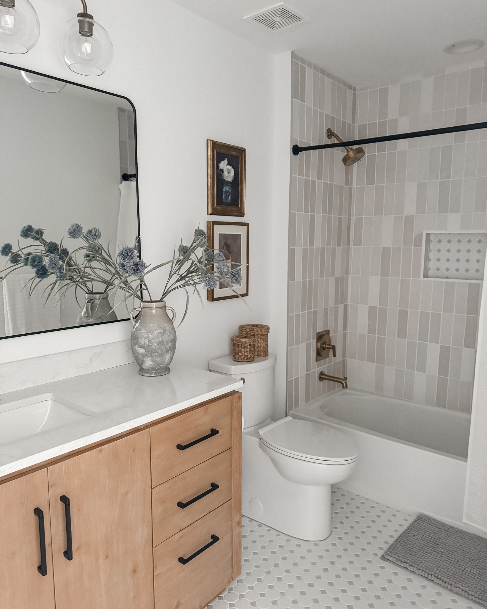 Bathroom DIY Reveal 🤍

Wall Paint: McCormick Super White, flat finish

Floor Tile: Octagonal Porcelain Mosaic Tile White & Grey from Mineral Tiles (linked similar)

Wall Tile: Zellige Pearl Opal Polished Ceramic Tile from Floor & Decor (linked similar)

Grout/Caulking: Artic White from The Home Depot (exact linked)

Vanity: San 60'' Single Bathroom Vanity with Cultured Marble Top in Fir Wood Brown from Wayfair (exact one linked)

Vanity Faucet: Ryden Single Hole Single-Handle Bathroom Faucet in Brushed Gold from The Home Depot (exact one linked)

Mirror: Forbath Large Bathroom Mirror 36 x 55 Inches from Amazon (exact one linked)

Vanity Light Fixture: Reagan Quadruple Globe Sconce from Pottery Barn (exact linked & on clearance) 

Bathroom Hardware (towels/toilet paper:) Chamberlain 3-Piece Bath Hardware Set with 24 in. Towel Bar, Toilet Paper Holder, Towel Ring in Champagne Bronze from The Home Depot (exact linked)

Shower Fixtures: Castia By Studio McGee Rite-Temp Bath And Shower Trim Kit 1.75 GPM in Vibrant Brushed Moderne Brass from The Home Depot (exact linked)

Toilet: American Standard Clean White Elongated Chair height Soft Close 2-piece Toilet 12-in Rough-In WaterSense 1.28 GPF from Lowes (exact linked)

Toilet handle: KOHLER 1034693-VF Replacement Part,Polished Brass from Amazon (exact linked)

Shower Rod: BRIOFOX Shower Curtain Rod Adjustable 18-78 Inch, Stainless Steel Spring Tension Shower Rod No Drilling Non Slip, Matte Black from Amazon (exact linked)

Decor & Accesories: linked everything that I could (frames are old from Target) 🤍


#LTKHome