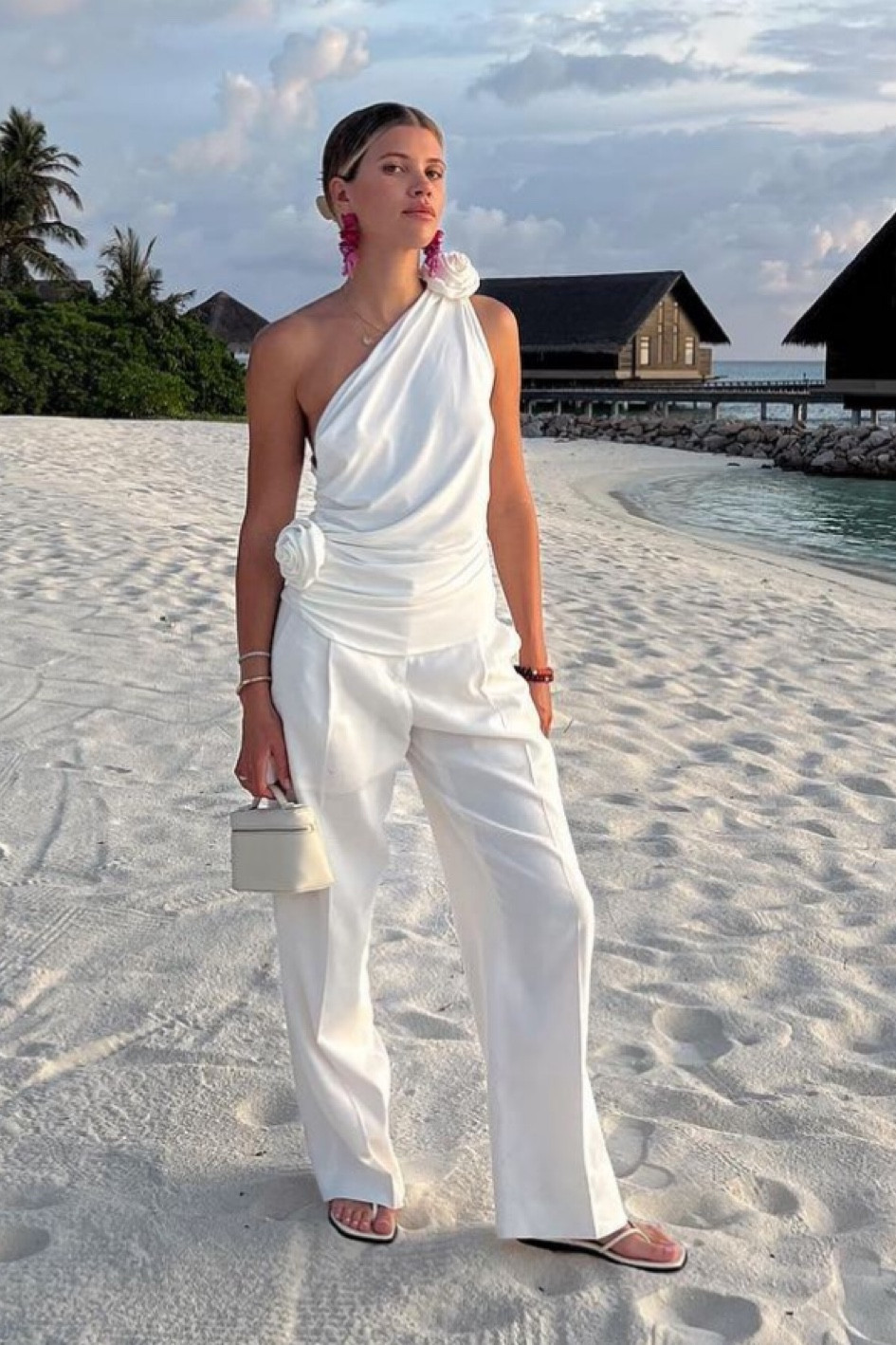 Sophia Richie's one shoulder rose appliqué white top pouch leather pro body bag white trousers thong sandal

#LTKFind #LTKwedding #LTKstyletip