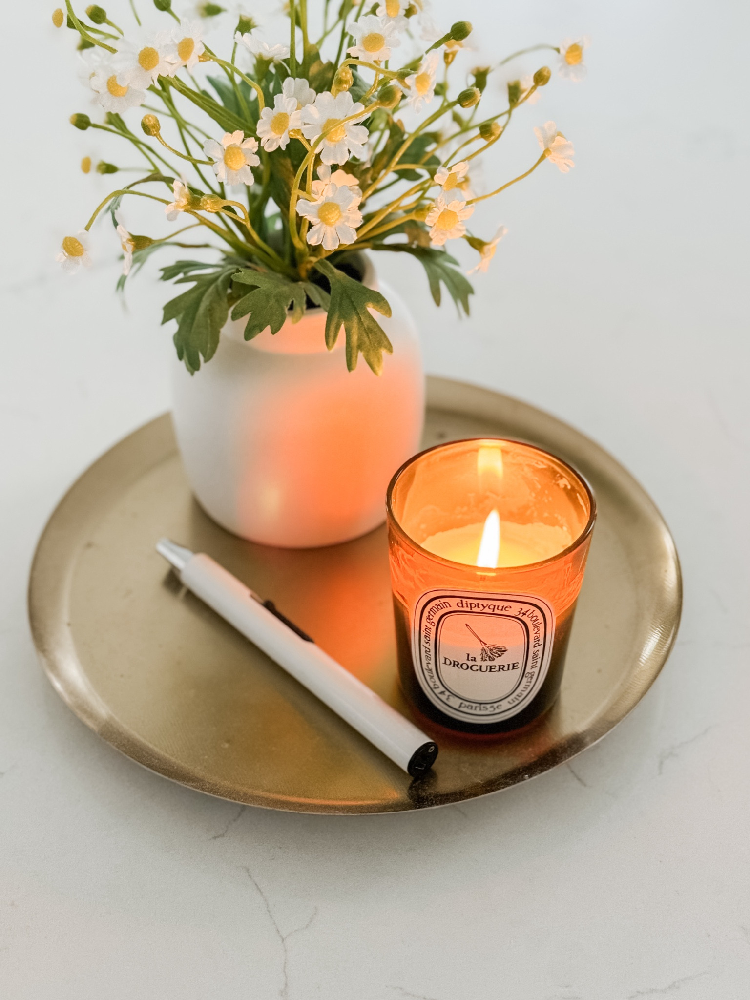 I don’t know how it took me so long to discover this “La Droguerie” candle scent by Diptyque, but I love it so much. It’s perfect to use in the kitchen, especially after cooking (or reheating) foods with strong scents. It smells herbal & fresh and helps to neutralize odors. 🕯️
*My candle tray is called the “Round Gold Reactive Metal Candle Plate” from World Market which can’t be linked, but it’s great!

#LTKhome