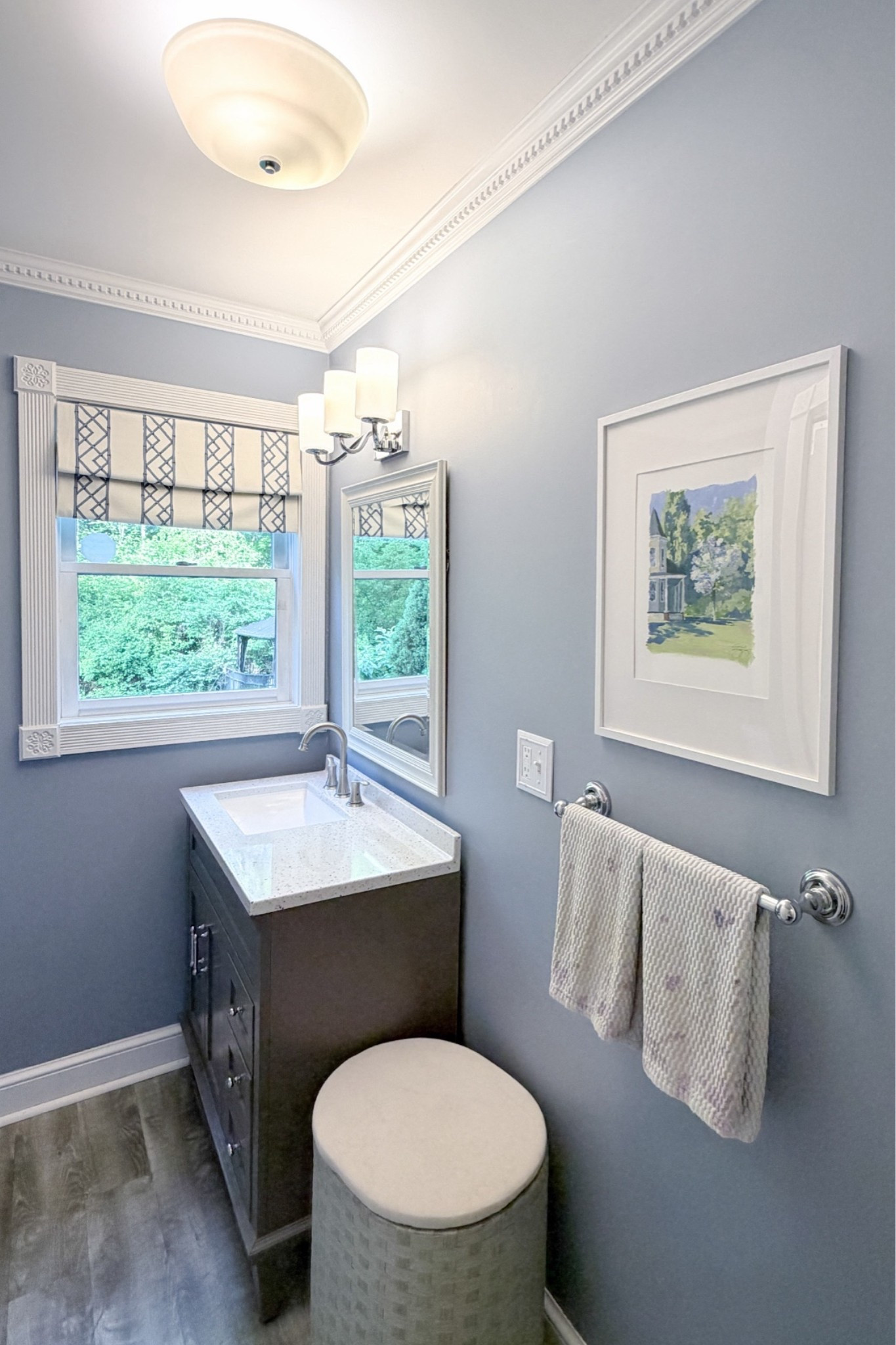 Powder bath refresh on a budget. I started this DIY powder bath refresh by painting the bathroom the prettiest shade of blue. I customized a plain roman shade by adding an additional layer of designer fabric using iron on hem tape, swapped the outdated lighting for the cutest chrome & milk glass light fixtures, and added in coordinating chrome bathroom hardware to hang hand towels on.

#LTKHome