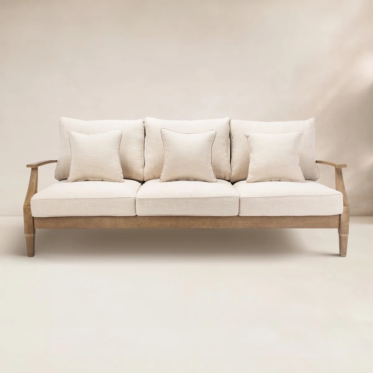 This outdoor patio sofa from Wayfair is the definition of elevated backyard lounging. The light wood frame paired with plush neutral cushions gives it that clean, modern look that works with any outdoor setup. Perfect for hosting, relaxing, or creating a cozy outdoor living space for warm nights. 