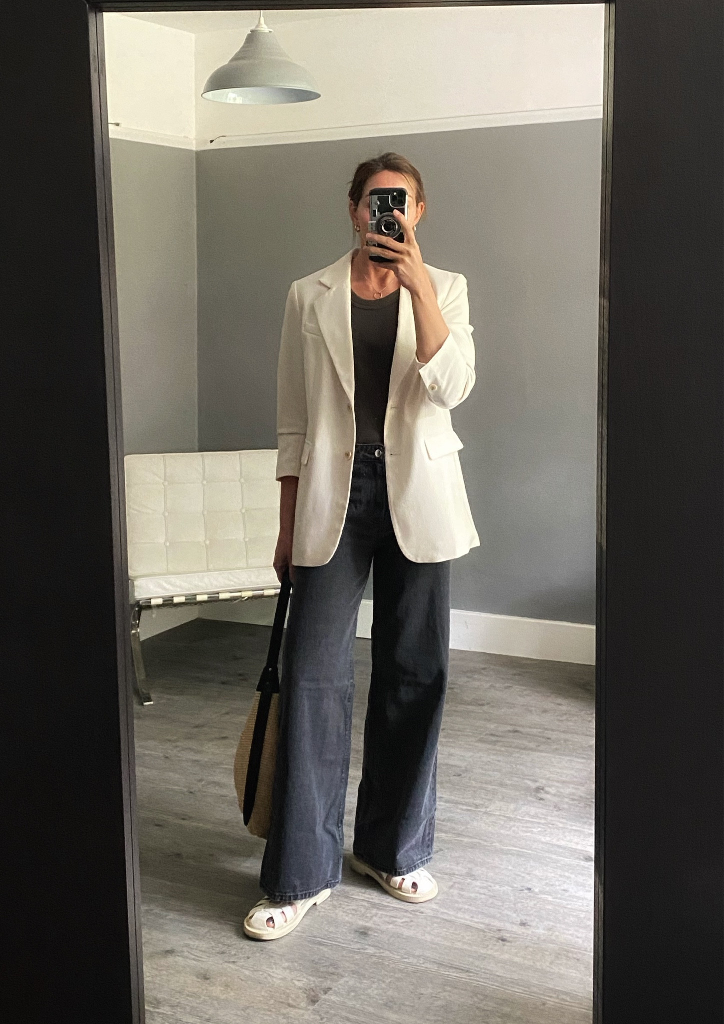 Cream white blazer, grey vest and wide leg grey black jeans - add fisherman sandals for a summer look.