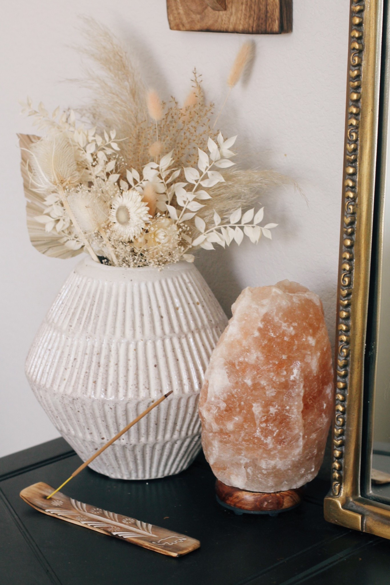 
Little ways I add calm and cozy to my bedroom space:  soft glow lighting with twinkle candles and a salt lamp + a lovely dried wildflower bundle + patchouli incense burning ✨ (one of my favs, smells soo good)

My soft neutral bedroom corner styling with cozy, earthy vibes ✨ carved wood wall sconce with a glowing candle, a textured ceramic vase filled with dried florals and pampas grass, and a warm Himalayan salt lamp for that perfect ambient glow. Paired with a vintage-style mirror and burning patchouli incense, this space blends minimalist decor with a subtle boho touch; ideal for creating a peaceful, grounded home aesthetic.


#LTKHome #LTKselfcare