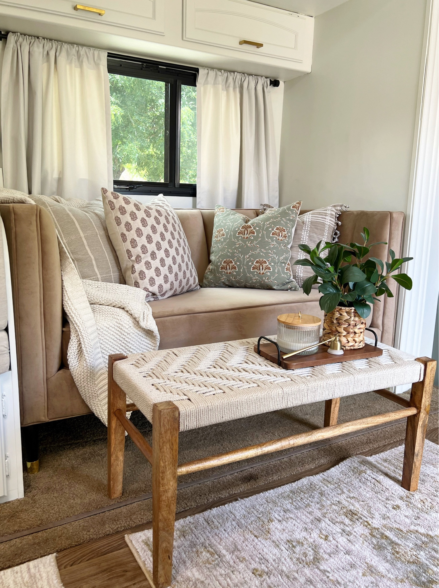 Camper living space decorated for fall with affordable finds from Target and Walmart. RV, Threshold, Studio McGee, Hearth & Hand, Better Homes & Gardens,   World Market, throw pillow, knit blanket, woven bench, candle, area rug, faux plant, modern farmhouse, cottage, camping, fall decor 

#LTKhome #LTKstyletip #LTKSeasonal