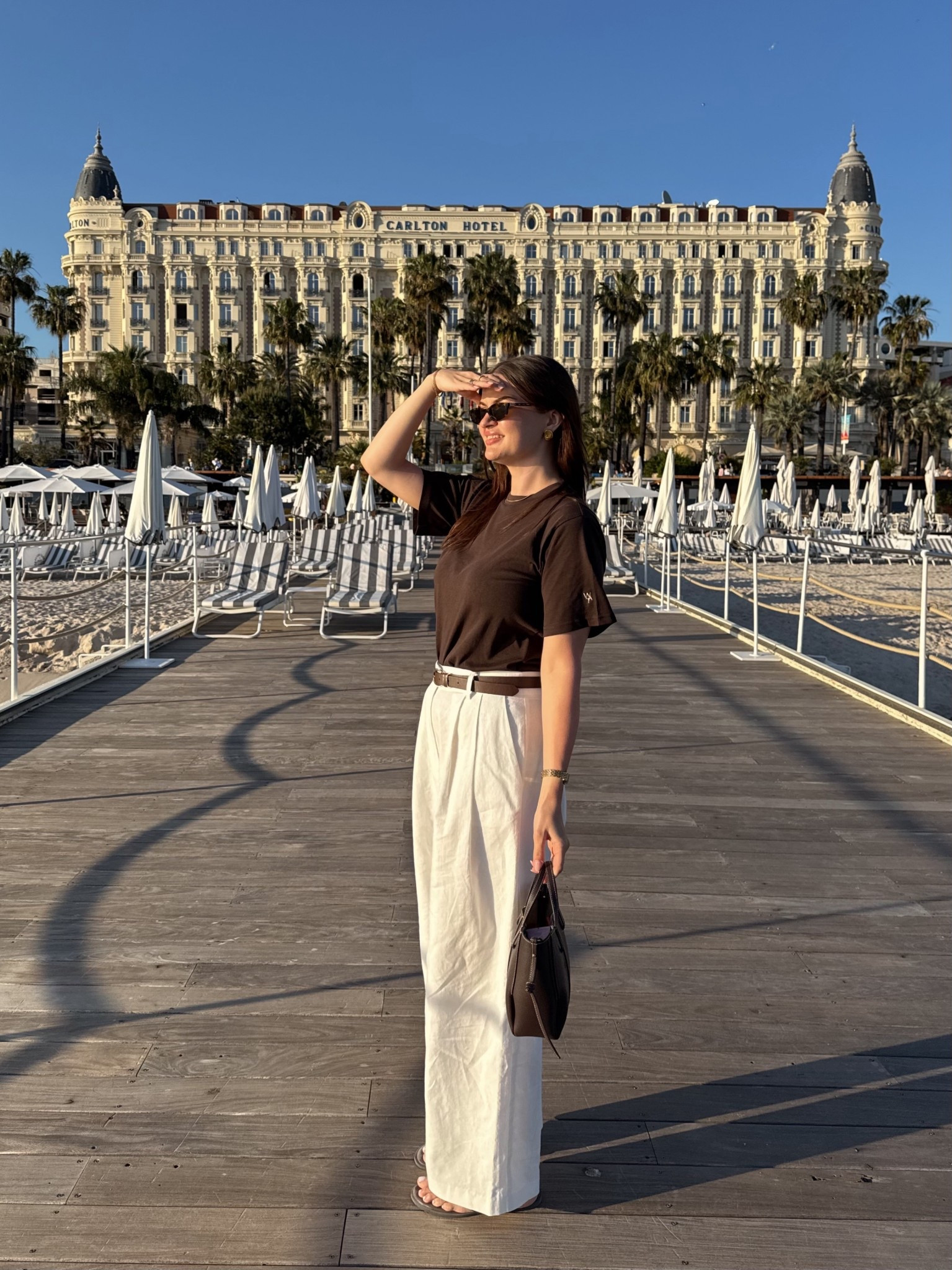 South of France summer holiday outfit - wat the brand brown t shirt & barrel leg white linen trousers, styled with new look brown flip flops & polene Paris handbag

#LTKsummer #LTKuk #LTKstyletip