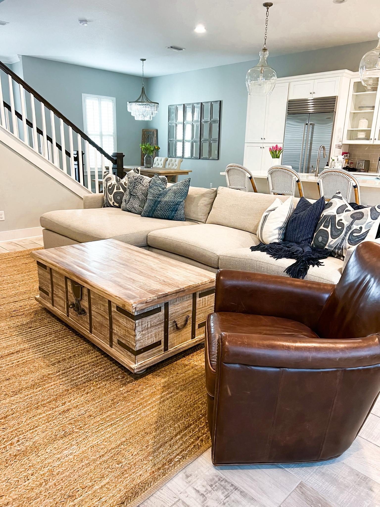 Living room. Pottery barn coffee table. Dining room. Neutral furniture. Coastal home decor. Neutral decor. Pottery Barn chest coffee table (love the storage inside)! Pottery Barn dining room table. Driftwood furniture. Pottery Barn leather swivel chair. Serena and Lily Riviera counter stools (so easy to clean!!). Crate and Barrel couch - 2-Piece – Left-Arm Chaise + Right-Arm Sofa configuration in Taft pearl! Pottery barn pendant lights. 

#LTKfamily #LTKfindsunder100 #LTKhome