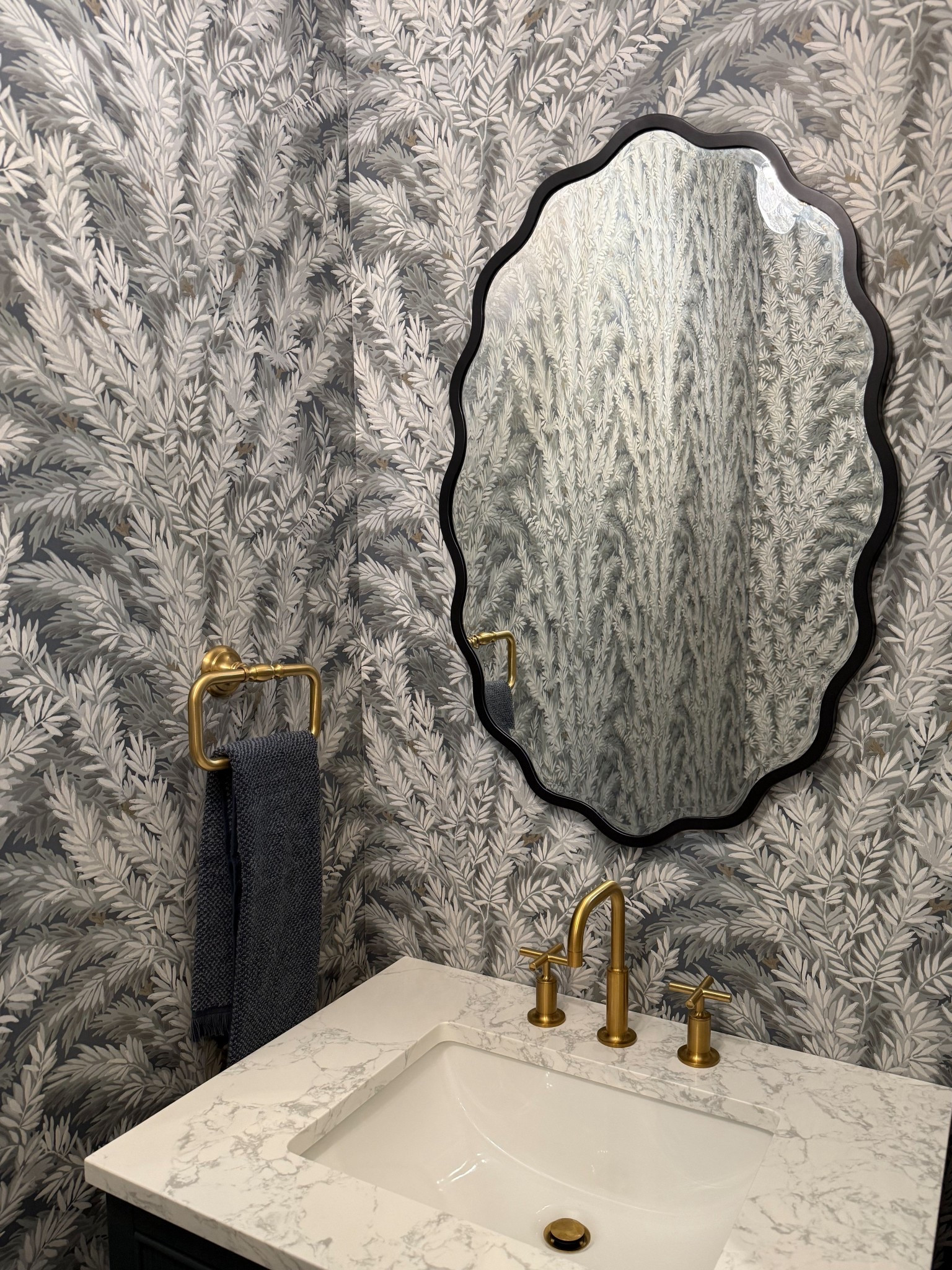 One of my favorite powder rooms to date! Love this statement wallpaper, gorgeous vanity, wavy mirror and brass accents 🙌🏻 The prettiest bathroom! 

#LTKFindsUnder100 #LTKStyleTip #LTKHome