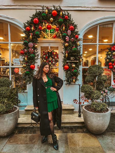 Chic holiday outfit. Green pleated skirt with green blazer and a long black coat and boots. #holidayoutfit 

#LTKstyletip #LTKHoliday #LTKFind