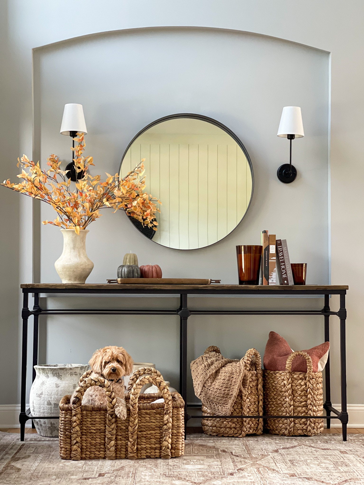 Entryway decor, foyer, console table, pottery barn, puppy, baskets, fall decor, interiors, home decor, home style, holiday vibes, cozy living, round mirror, sconces, fall stems, vases, candles, home design, black door, magnolia, loloi 

#LTKhome #LTKSeasonal #LTKHalloween