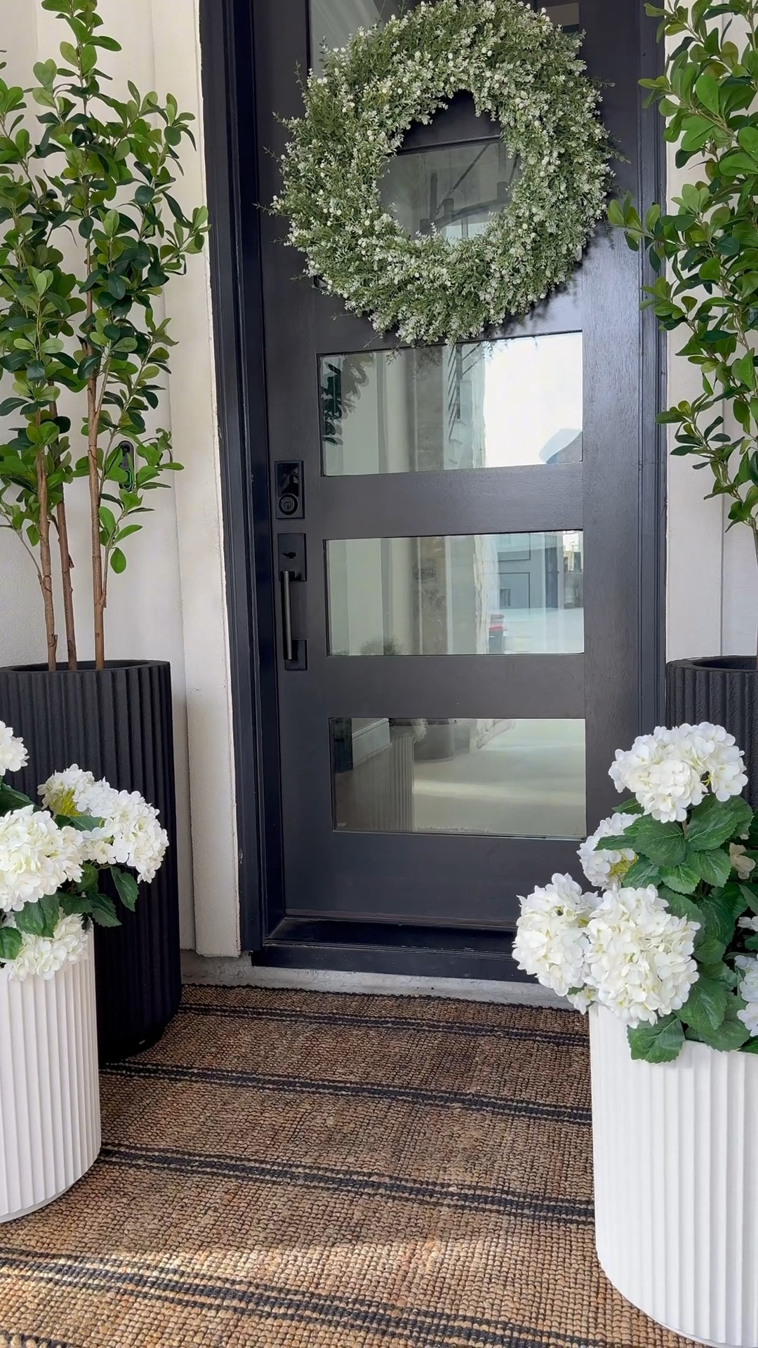 The fluted planters completely stole my heart.....the tall black ones add contrast, the shorter white ones soften everything.🥰

You know I love a black + white foundation 😆 ....& this rug
adds the right amount of warmth. It worked through fall and winter and I already know it'll carry us into summer too.

I layered in hydrangeas (because I can never have too many) 😜 & added small green trees to liven up the space.

And this oversized wreath... such a beautiful statement. This space feels so good!☺️

Create your own space! Click link to shop!

#LTKHome #LTKSaleAlert #LTKSpringSale