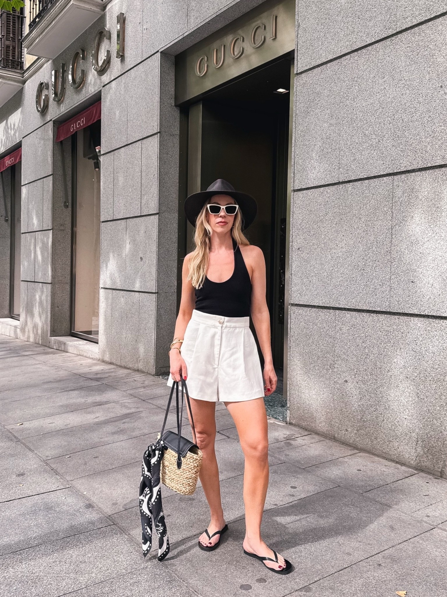 Summer vacation outfit, Euro summer, halter top, white linen shorts, black thong sandals, @Janessa Leone straw hat, black and white summer outfit idea

#LTKTravel #LTKSeasonal #LTKOver40