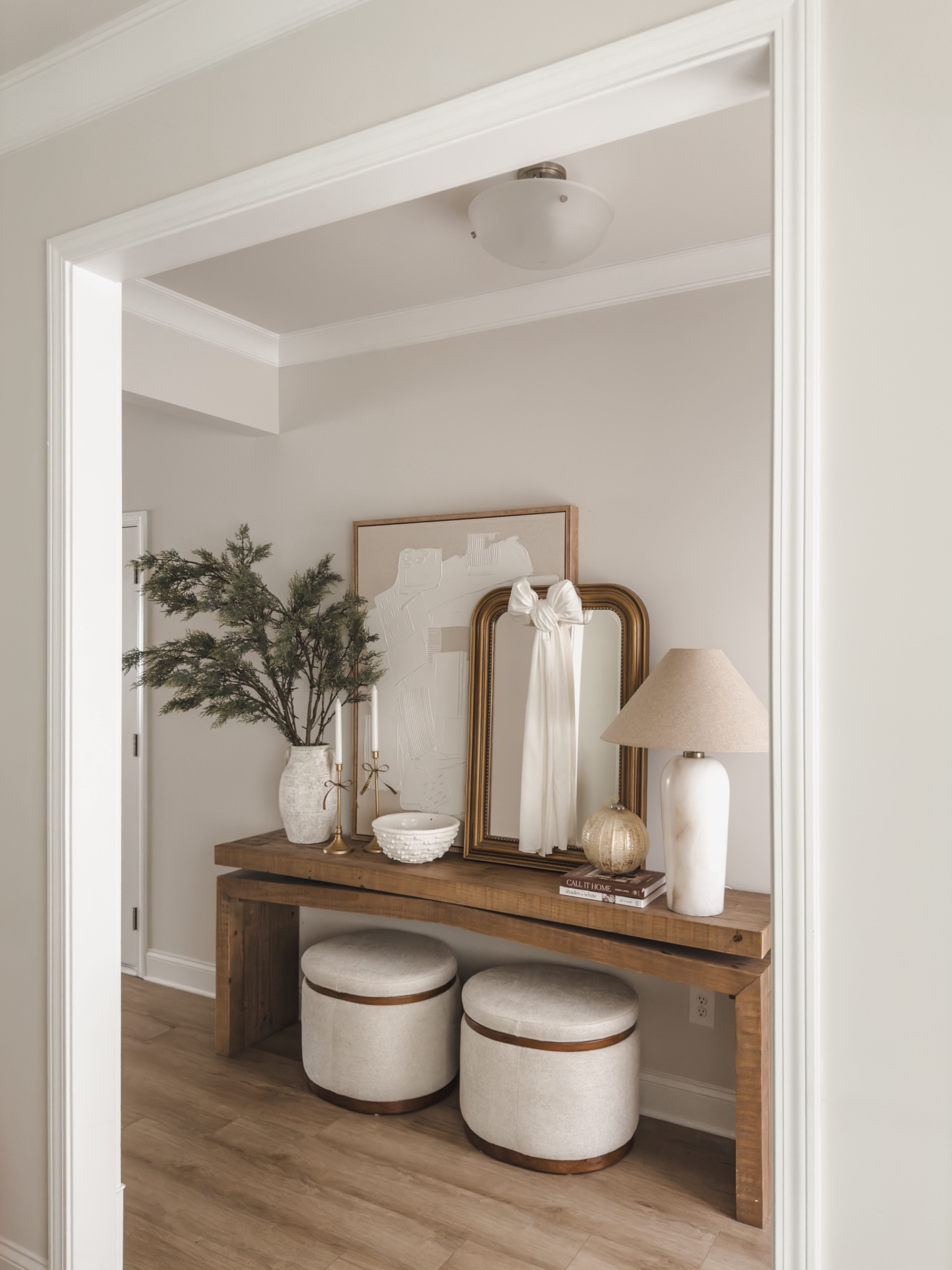 Front entry styled for Christmas with faux winter greenery, linen storage ottomans from Chita living, gold accents and warm wood tones! 

All things Christmas, home for the holidays, Christmas style, look for less, holiday style, furniture finds, wayfair furniture finds, Henn console table, pottery barn style, shop the look! 

#LTKSeasonal #LTKHome #LTKHoliday