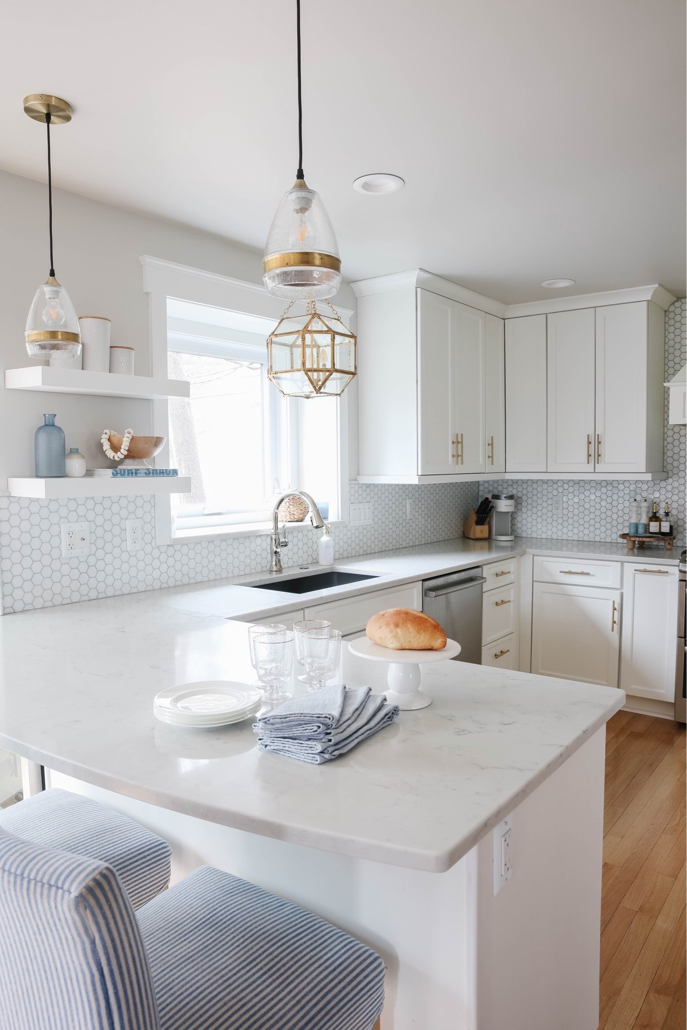 This white coastal kitchen is light, bright and airy! The brass pendant light adds the perfect touch to the whole space!

#LTKHome #LTKSaleAlert