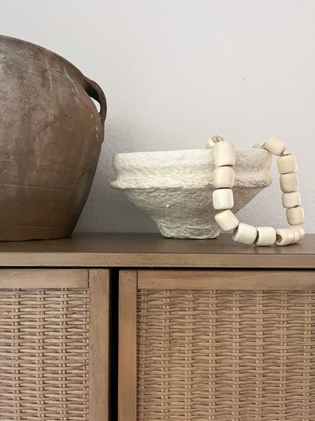 Top of cabinet styling ideas with clay pot, paper mache bowl and bead garland 

#LTKhome #LTKstyletip #LTKfindsunder50