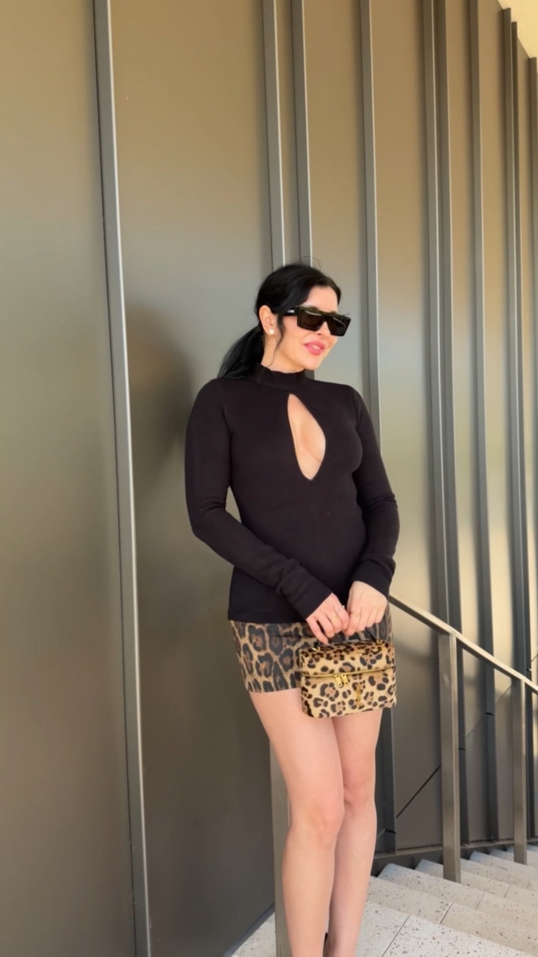 Black cut out sweater top and leopard mini skort with YSL leopard vanity bag 

#LTKgrwm #LTKootd