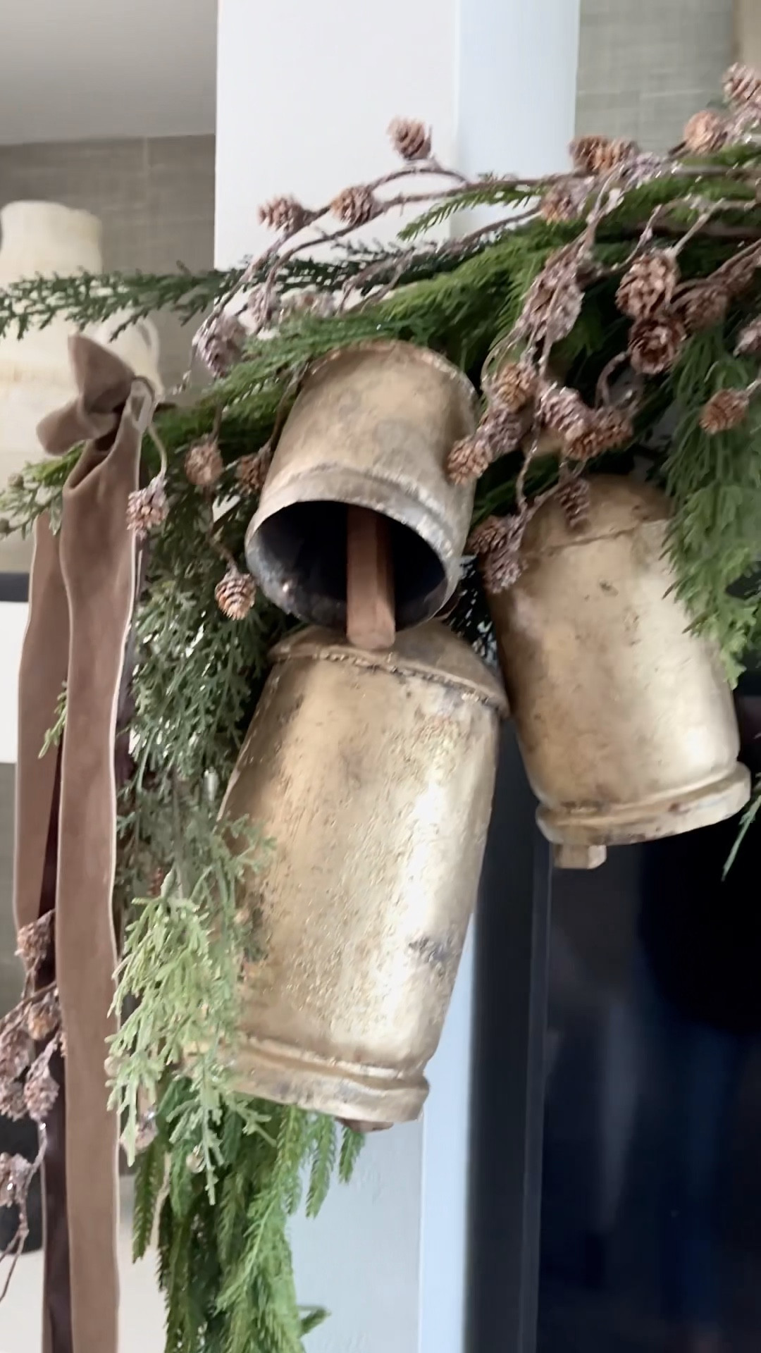 Christmas Mantle Decor
Norfolk pine garland, cedar garland, gold bells, brown velvet ribbon  pinecone stems
#founditonamazon #michaelsstores

#LTKHoliday #LTKSeasonal #LTKhome