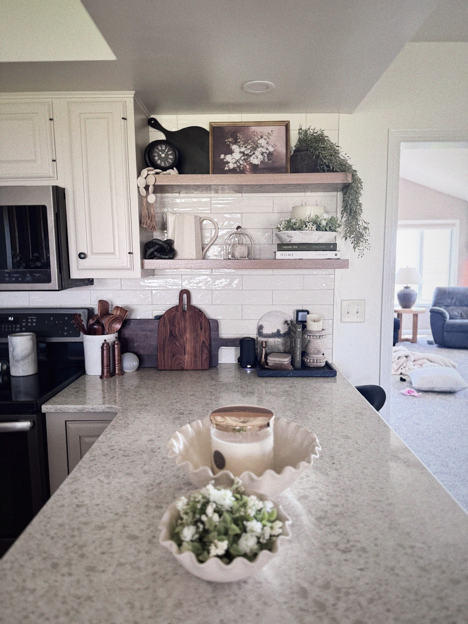 Calm mornings hit different in this cozy kitchen 🤍 Linked my favorite neutral kitchen finds — from the scalloped bowl to the faux florals and wood accents. Tap to shop the look that brings warmth and simplicity to your space. #LTKHome #NeutralKitchen #ScallopedBowl #HomeDecorLover
