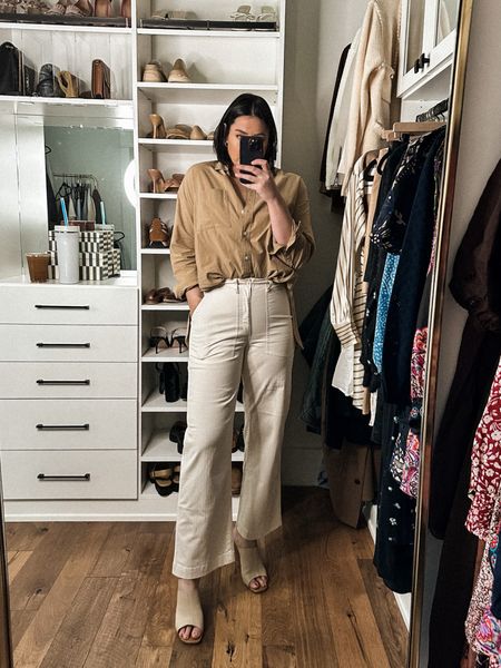I am in the medium of the top and it was a huge favorite from this month’s capsule! It wasn’t in stock in this color during my that first week of my capsule, but it’s in stock now!! Fit is just like the white one, oversized but true to size in an oversized way. If you are smaller up top or petite, go down a size. 

Here is the shirt tucked for a better reference. I’ve also worn it a lot in my capsule this month, too! I’ll link that here in a few slides. 

Okay so these pants were some of my best sellers from last year but in the brown color, so I decided to get them in the white this year! They are such an interesting cute — they are a utility pant but with the slightest little kick at the ankle. They are more fitted at the waist,  so I am in the 30 here. They stretch a bit with wear but are not stretchy, so if you have a rounder waist, go up one size. 

Comes in three colors, too! Highly recommend for spring. 