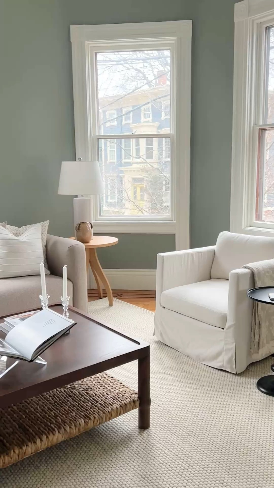 Curated neutral family room.  Large beige sofa with slipcovered swivel chairs.  Stunning vintage inspired coffee table.

#livingroom

#LTKHome