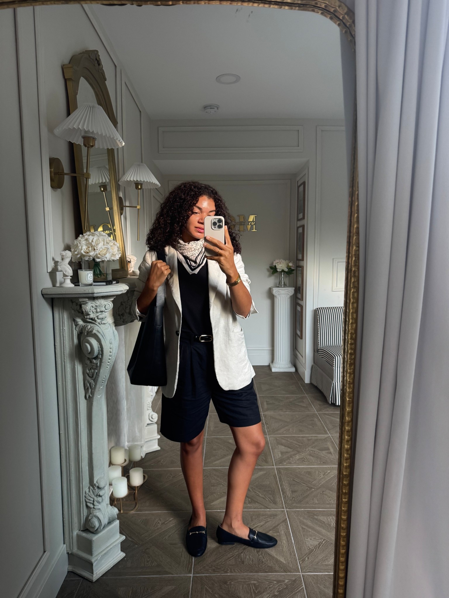 Classy fall outfit idea or work outfit idea: black top, long black shorts, loafers, blazer, scarf, and bucket tote 

#LTKItBag #LTKxMadewell #LTKWorkwear