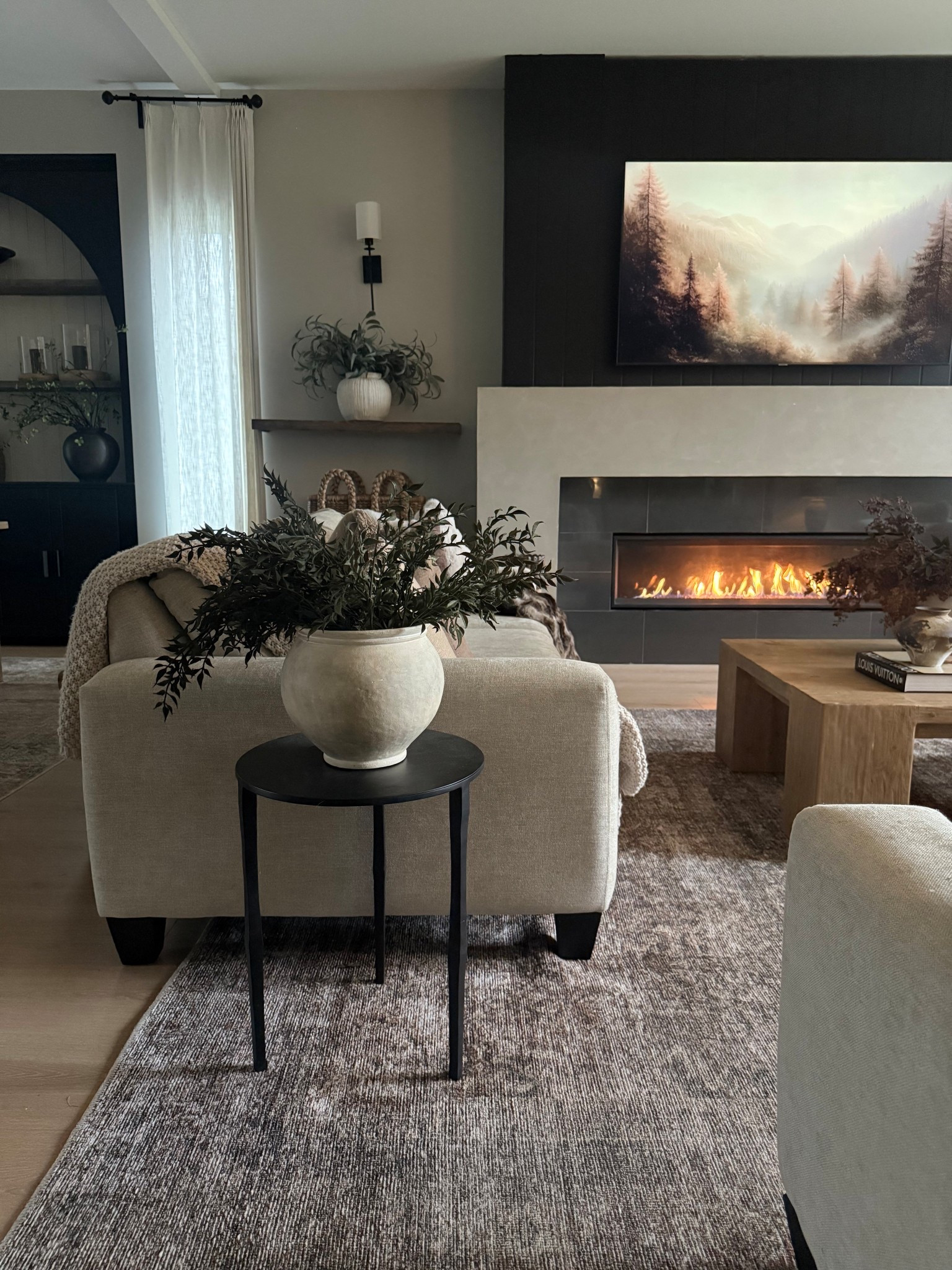 Our living room.. a mix of light/airy with moody/bold. This area rug helps tie everything together.