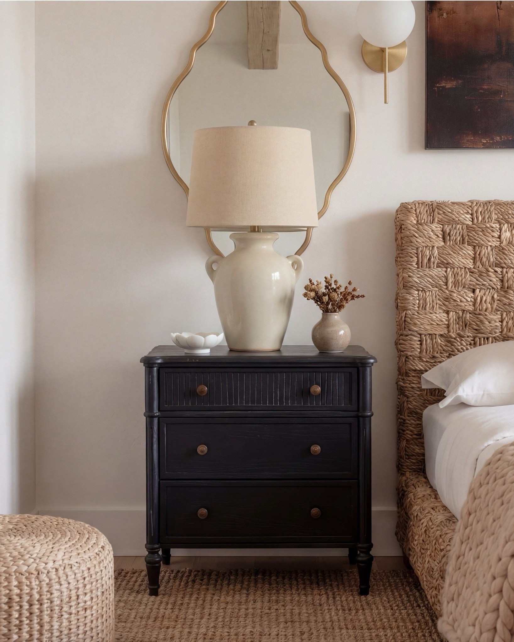 Shop the Look:
• Wood Woven rattan bed frame
• White upholstered mattress or box spring
• Black wood 3-drawer nightstands (set of 2)
• White duvet cover (hotel-style)
• White fitted sheet + pillow set
• Chunky knit throw blanket (beige or oatmeal)
• Neutral patterned accent pillow
• Brass globe wall sconces
• Cream ceramic table lamp with beige shade
• Large abstract landscape wall art (neutral tones)
•brown floral wall art
• Gold irregular curved scalloped wall mirrors
• Round woven knit poufs
• Neutral geometric or diamond area rug
• Large white ceramic vase
• Small decorative bowl (white or stone)
• Ivory linen curtain panels
•wood upholstered accent chair 
•black terracotta vase
•wood rattan dresser
•brass decor tray
•black leaf decor bowl 
•decor books

#LTKsale #LTKhome #LTKstyletip