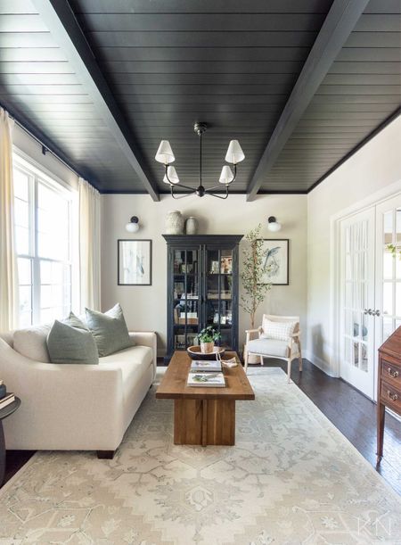 The Tricorn Black shiplap ceiling in our conversation room never gets old and is the perfect complement to the Edgecomb Gray walls. home decor living room decor pottery barn sofa glass front curio cabinet iron chandelier accent chair coffee table styling green linen pillows bird print

#LTKstyletip #LTKhome