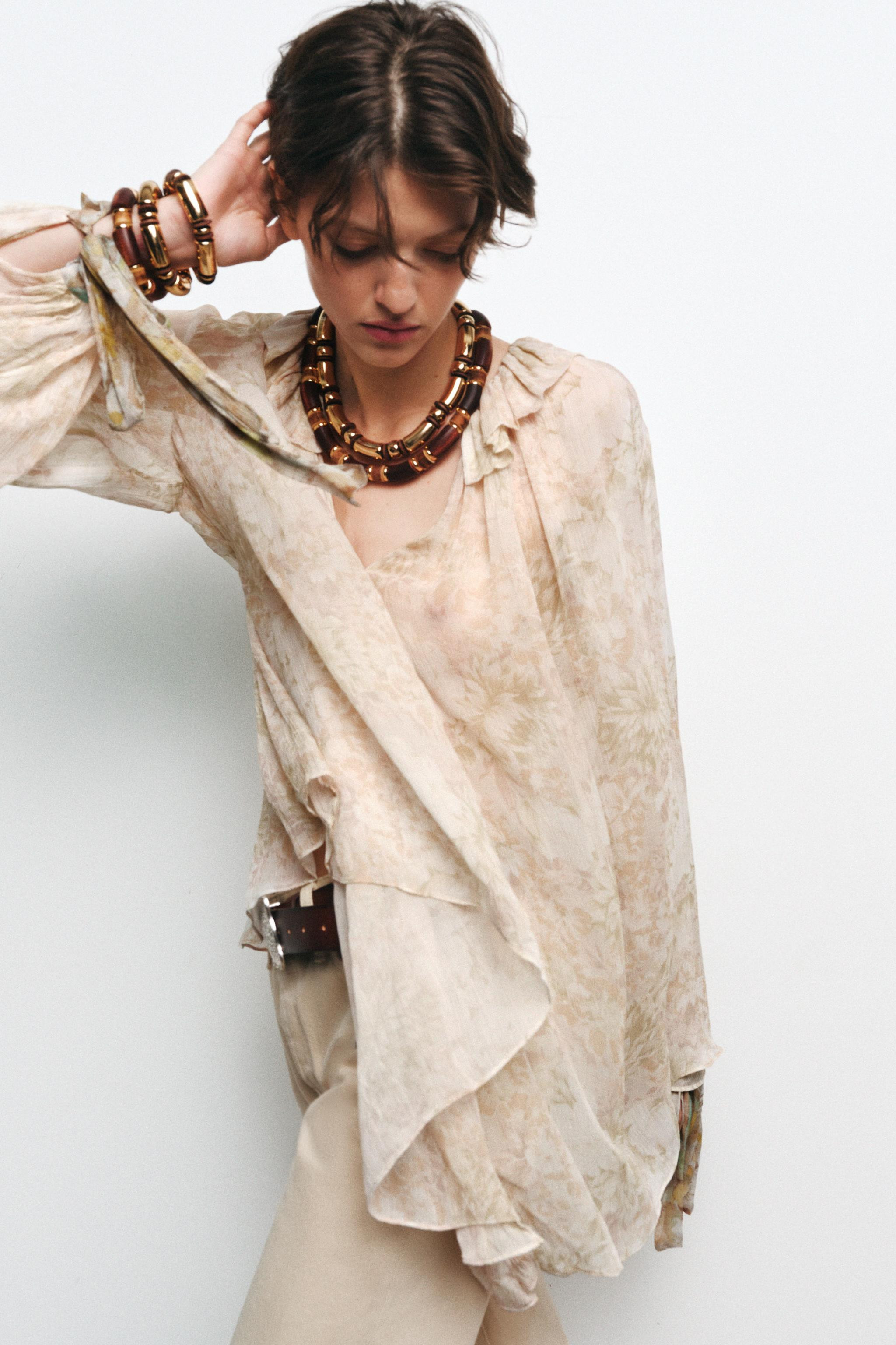 ZARA WOMAN COLLECTIONRound neck shirt with ruffle and adjustable drawstring V-neckline. Long slee... | Zara US