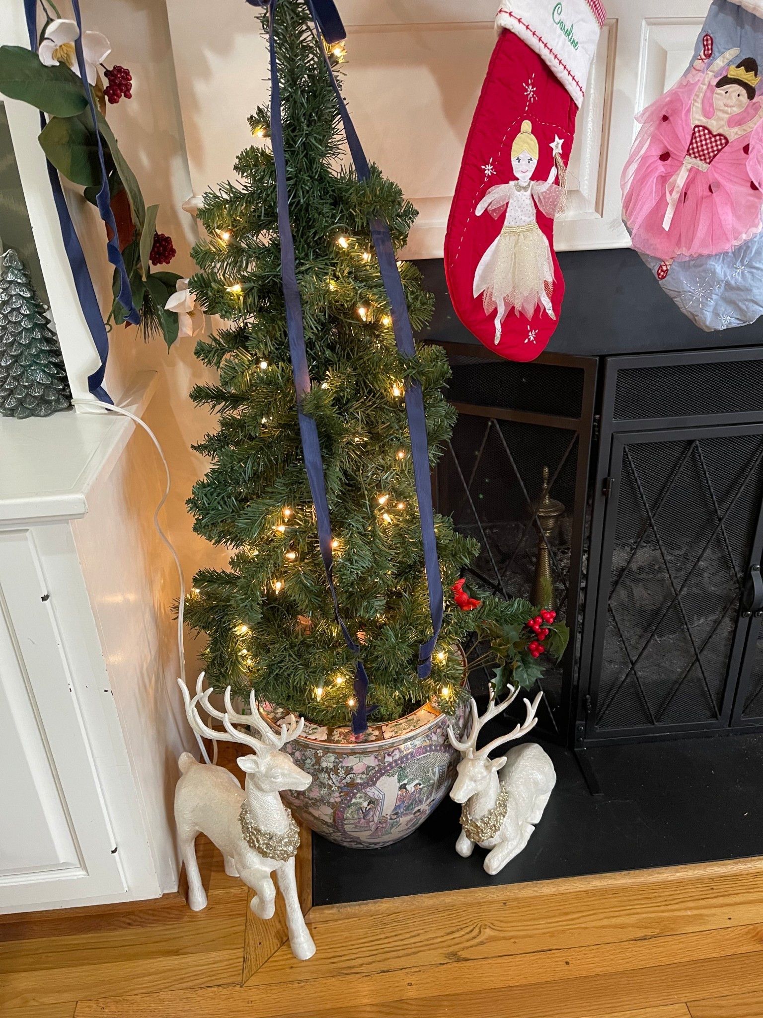 🦌✨ Petite Fireplace Tree with Chinoiserie Planter + White Reindeer Decor 🎄

One of my favorite corners to decorate for Christmas! I added a 4ft pre-lit tree inside this gorgeous oriental chinoiserie-style planter and tied it with navy velvet ribbon for a classic, elegant touch. The white jeweled reindeer figurines on each side bring in that soft, wintery sparkle and make the whole fireplace area feel magical. Paired with our sweet Pottery Barn Kids stockings, this little setup is festive, cozy, and so easy to recreate in any small space! 🎁🌟

fireplace Christmas decor • petite Christmas tree • chinoiserie Christmas • white reindeer figurines • elegant holiday decorating • small space Christmas ideas • velvet ribbon Christmas tree • classic Christmas style • blue and white decor • Amazon holiday finds 🎄✨

#LTKHoliday #LTKFindsUnder50 #LTKHome