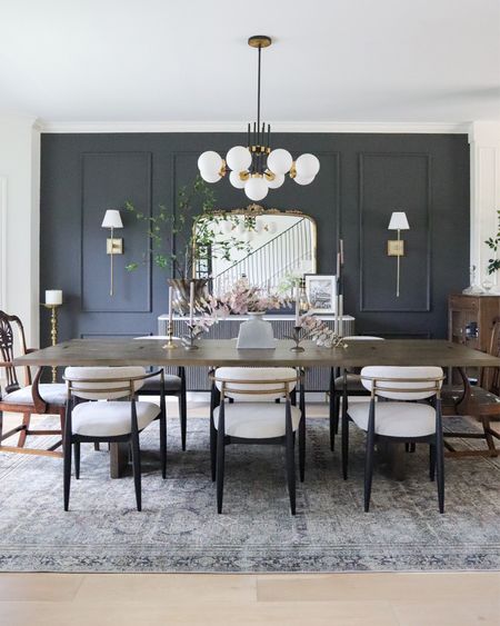 My dining room decor 🖤 

long wood rectangular dining table, Arhaus Jagger dining chairs, Loloi Layla rug in olive charcoal, modern black and brass chandelier, Arhaus Amelie mirror, fluted sideboard, wall sconces, centerpiece decor 

#LTKhome #LTKsalealert #LTKstyletip