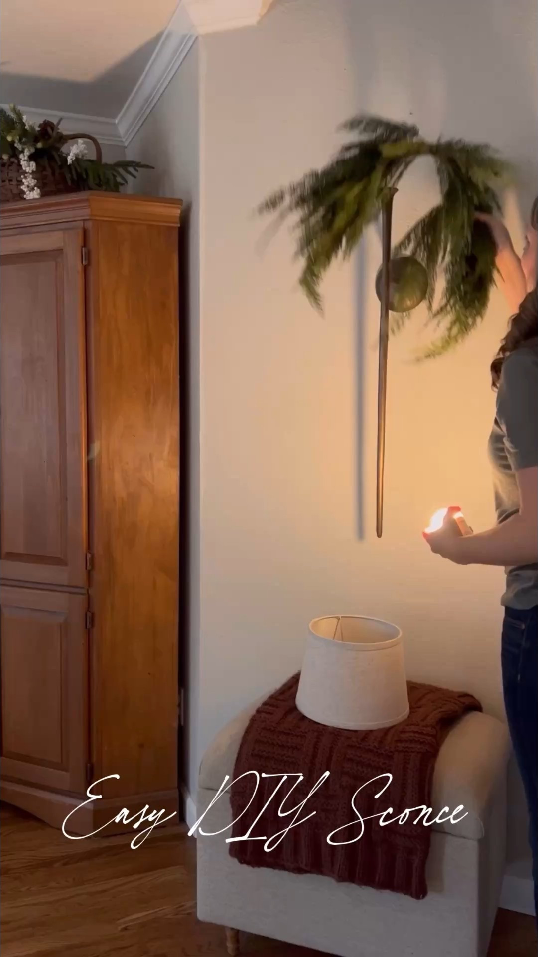 OK, let’s break it down:
This is actually a metal candle sconce I found on Amazon. I spray-painted it black and then used European gold Rub n Buff to get that perfect bronze color
I bought a lampshade off of target that fit perfectly. This is the uno type so the ring for it sits right on top of where the candle would go.
Then I bought a rechargeable lightbulb that fits right inside that space as well. I used a little bit of museum putty to help it attach.
Then I added my Christmas touches and it is functional all year long, but I it’s my favorite at Christmas. 
