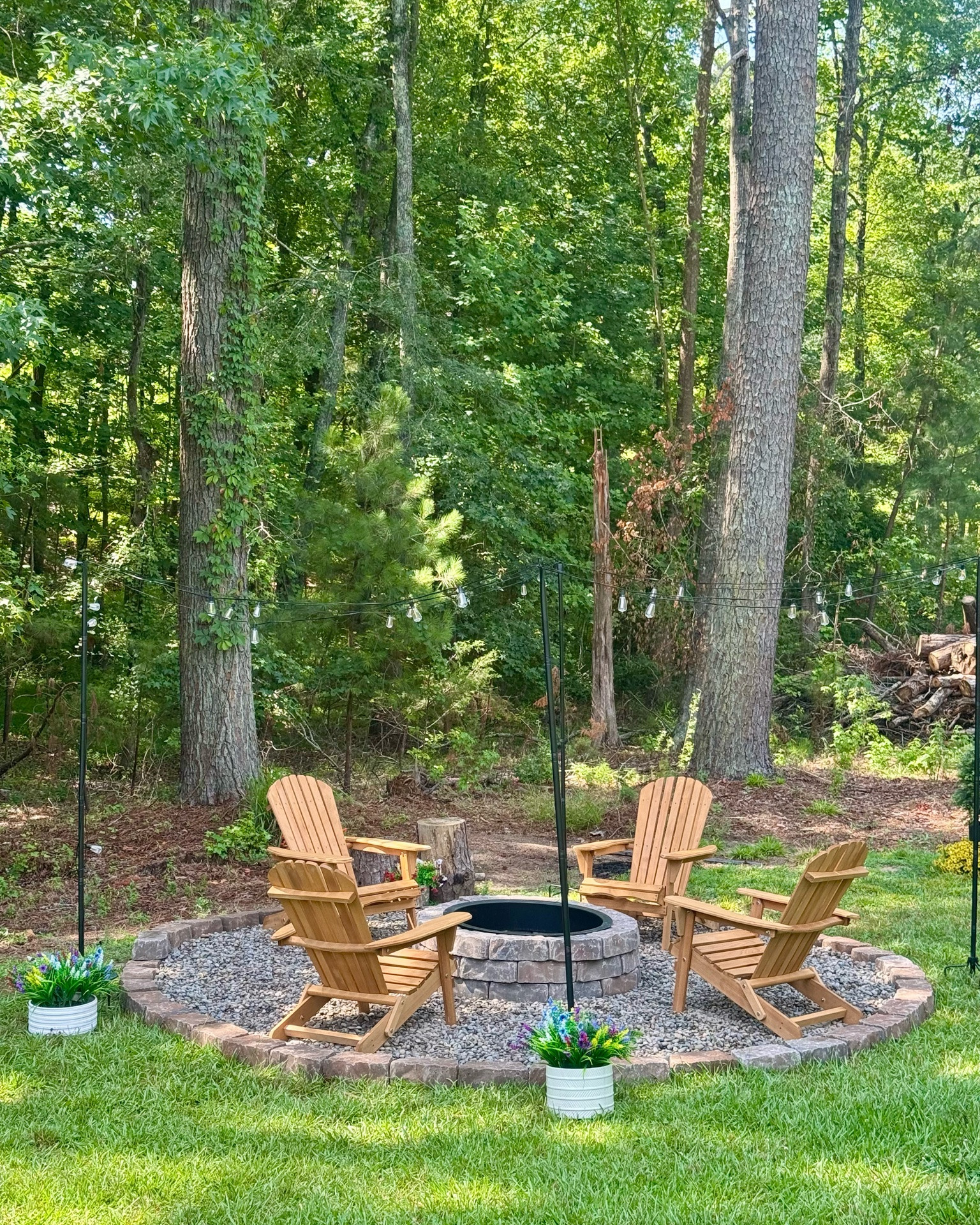 It’s finished! ✅ I cannot WAIT to sit around my new fire pit one cool evening while sipping a glass of wine. 🍷 Or have all the kids over for a s’mores night! 

We sat here this morning with a cup of coffee, but honestly it’s still too hot and humid outside. ☕️ 

We’re so blessed to be surrounded by such beauty! 🌳  ☀️ 🦌🦋🪴🌼🌸🪻

Chairs from Walmart and fire pit is from Lowe’s. Lights from Amazon.

#LTKSeasonal #LTKHome #LTKSaleAlert