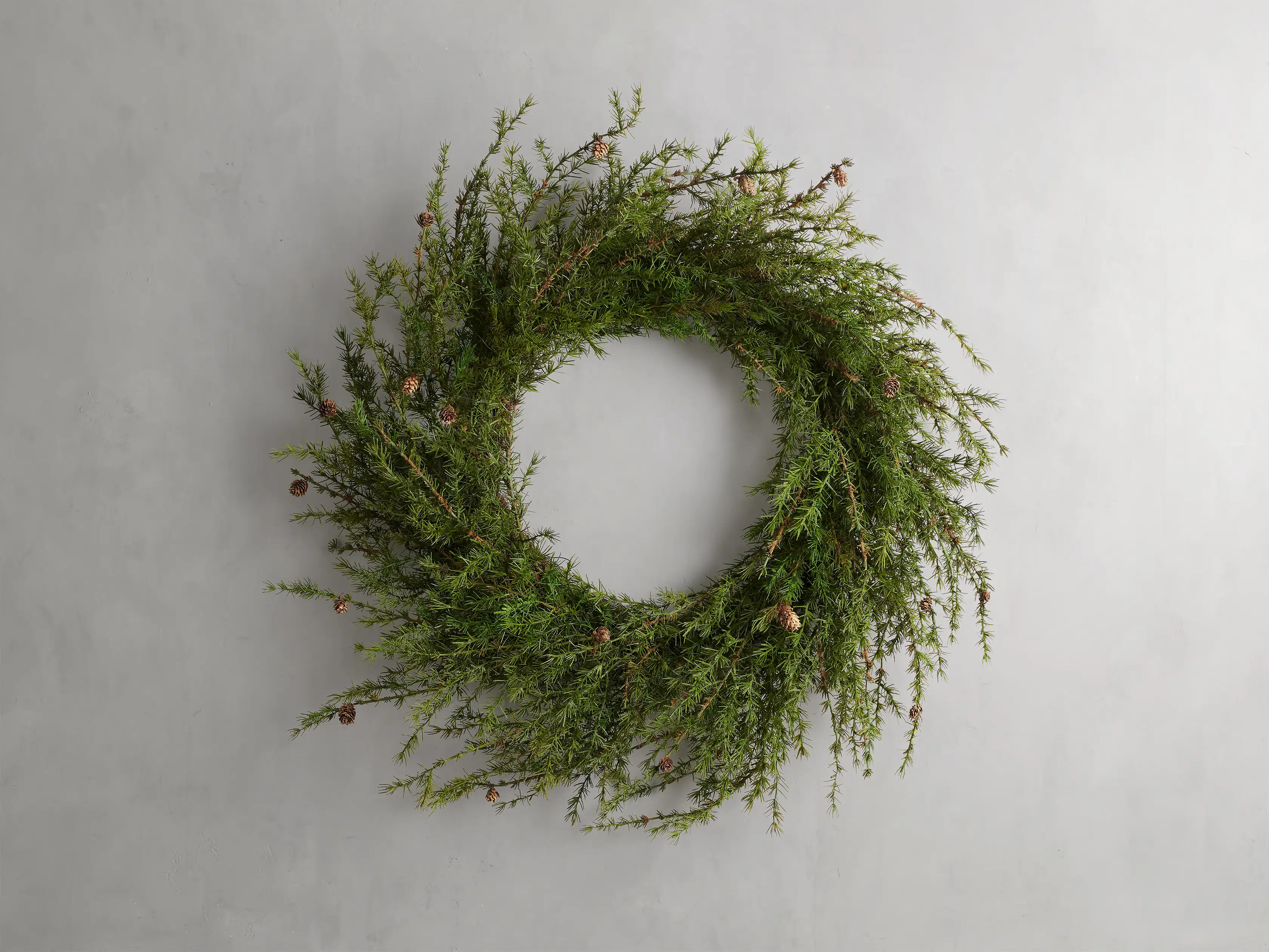 Crafted to capture the natural beauty of pine greenery, this Faux Pine Wreath will look fresh and... | Arhaus