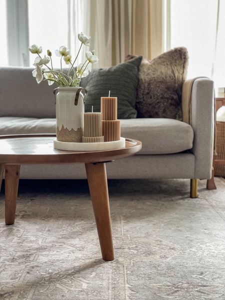 Neutral pillar candles and mid century coffee table. Washable neutral rug  

#LTKhome